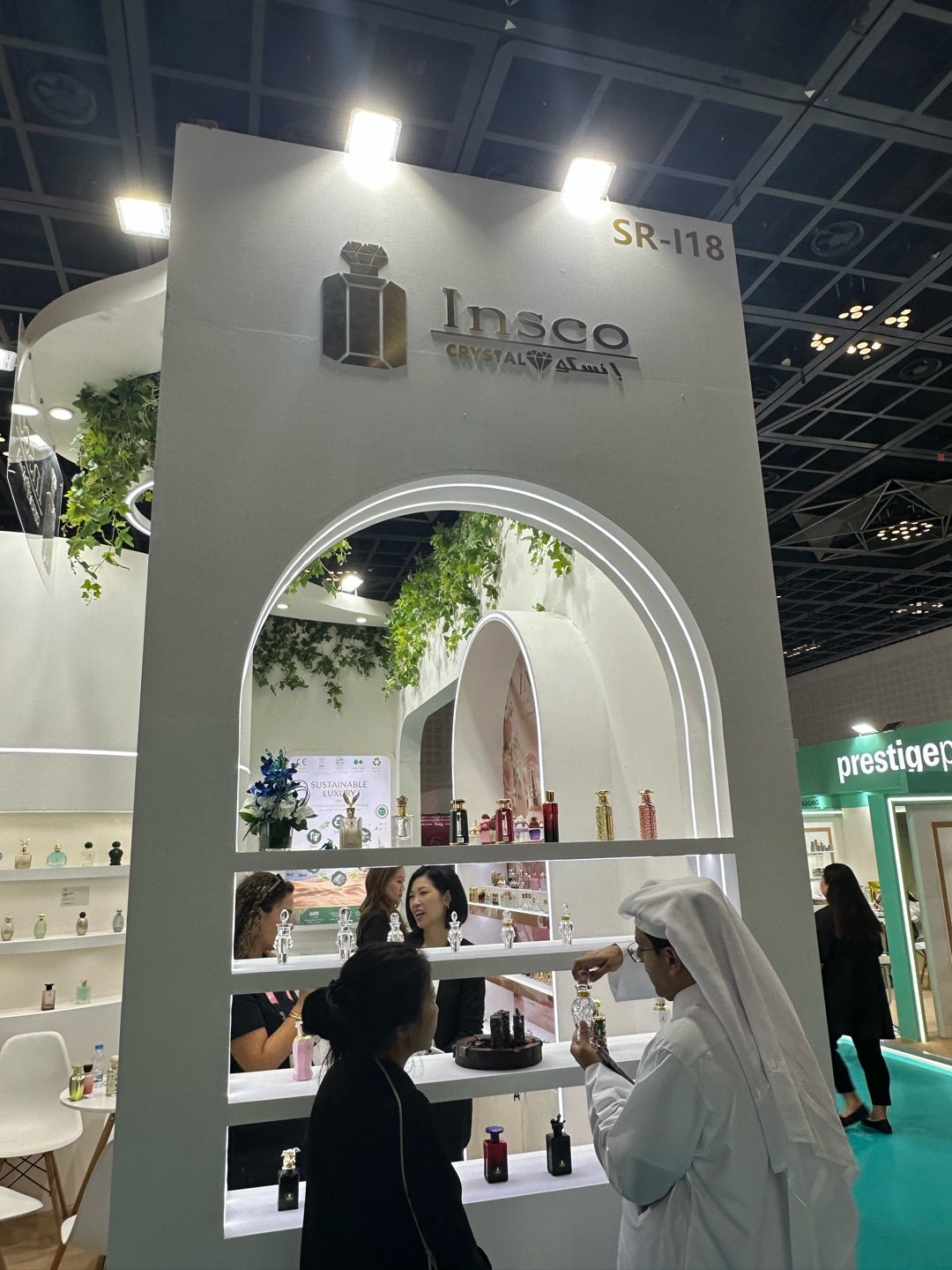 Visitors exploring INSCO crystal perfume bottles at booth SR-i18, Beautyworld Middle East 2026